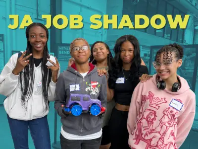 Students holding electric toy car
